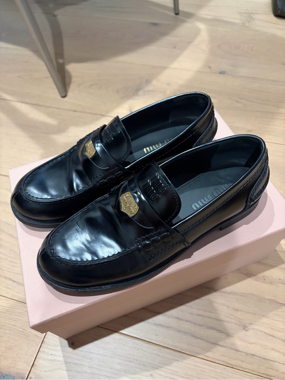 Miu Miu Black Leather Penny Loafers with Gold Emblem